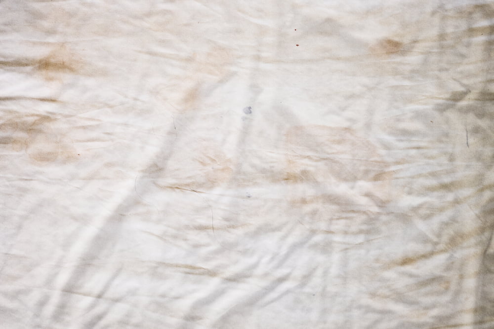 dirty and stained mattress and sheets
